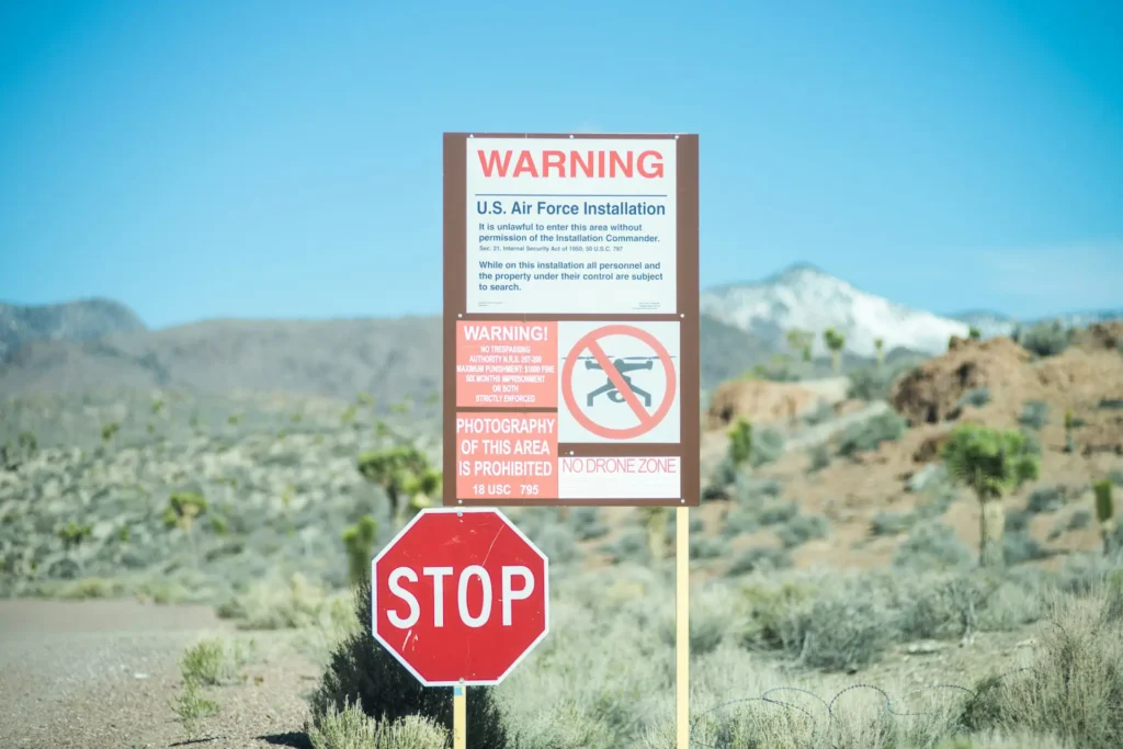 An Area 51 warning sign stating that you cannot enter, fly drones, or take pictures