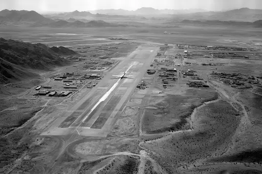 A representation of a black and white aerial photograph of a desert airstrip from the 1950s